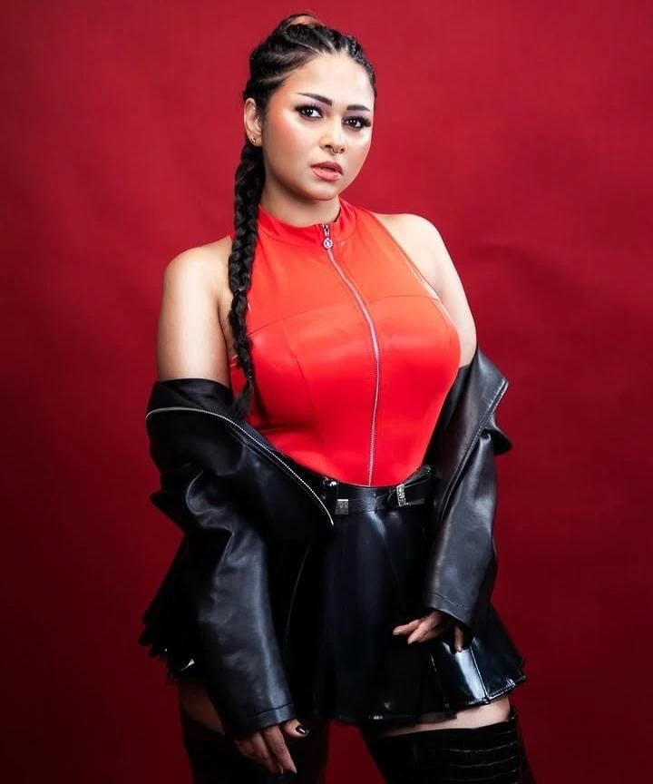 DJ Sanaah wearing a coral top and a black jacket