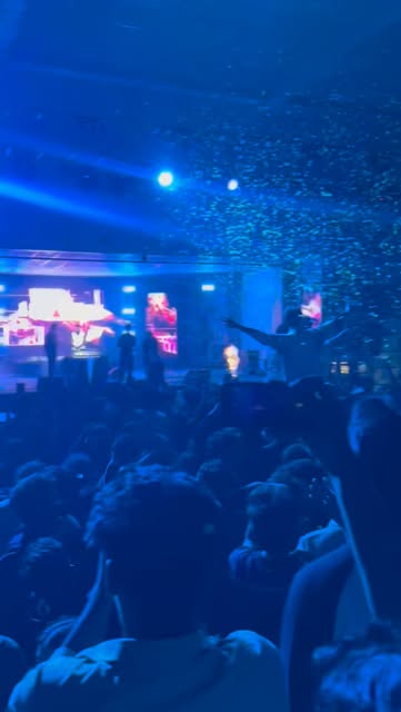 Crowd at the concert stage under lights and confetti