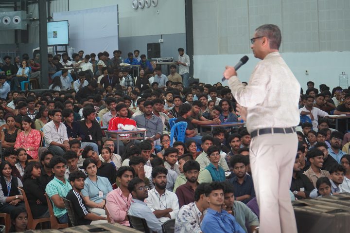 Guest speaker addressing a large seated audience